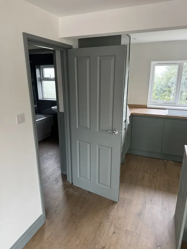 Painted internal door and kitchen doorway during finishing