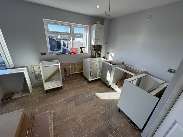 Kitchen cabinets being assembled and fitted